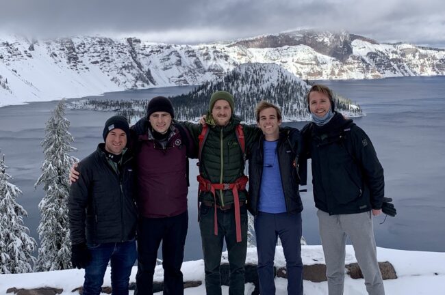 Tyba team in front of snow capped mountains